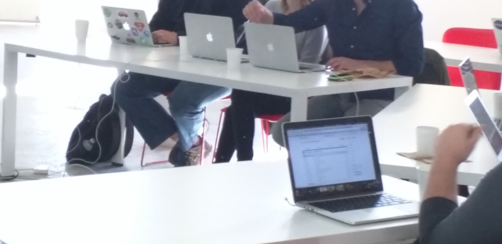A line of MacBooks on a table
