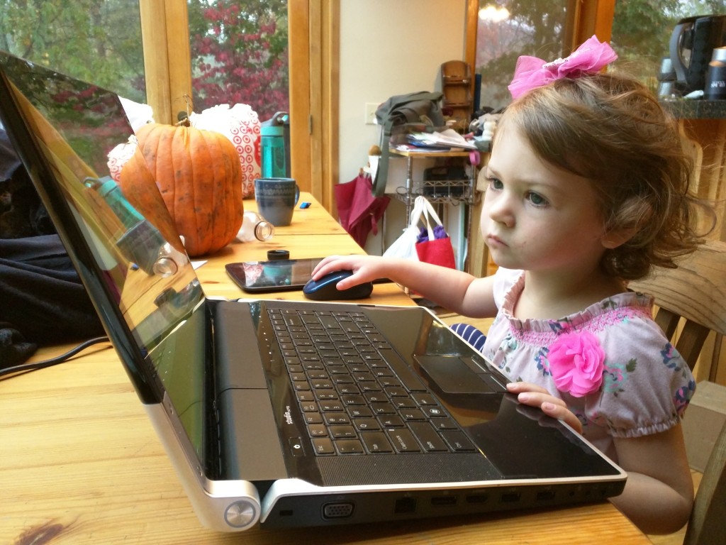Ylva, age 3, trying to use a large laptop